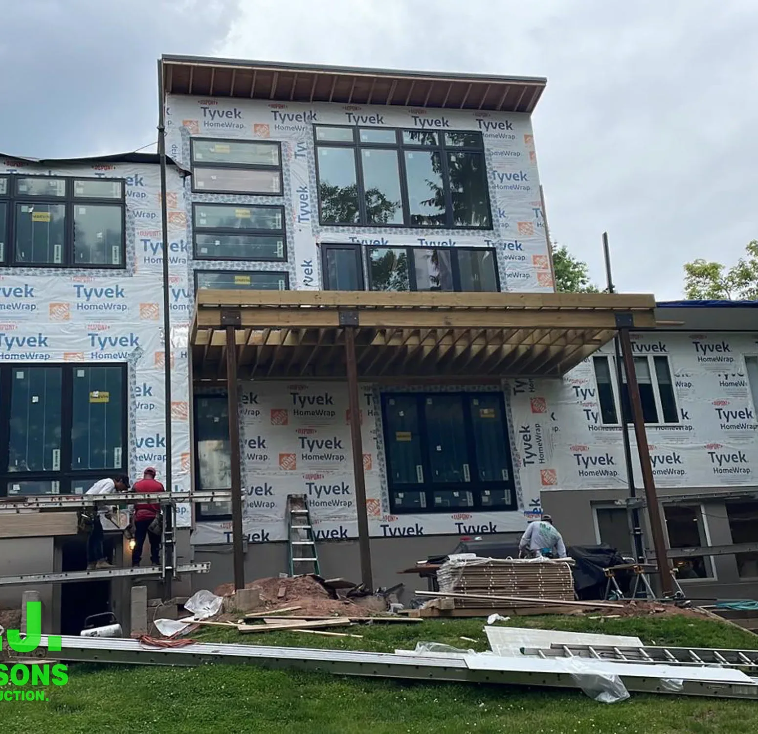 a residential construction site, emphasizing the house in its raw state with house wrap in preparation for the upcoming installation of Nichiha siding