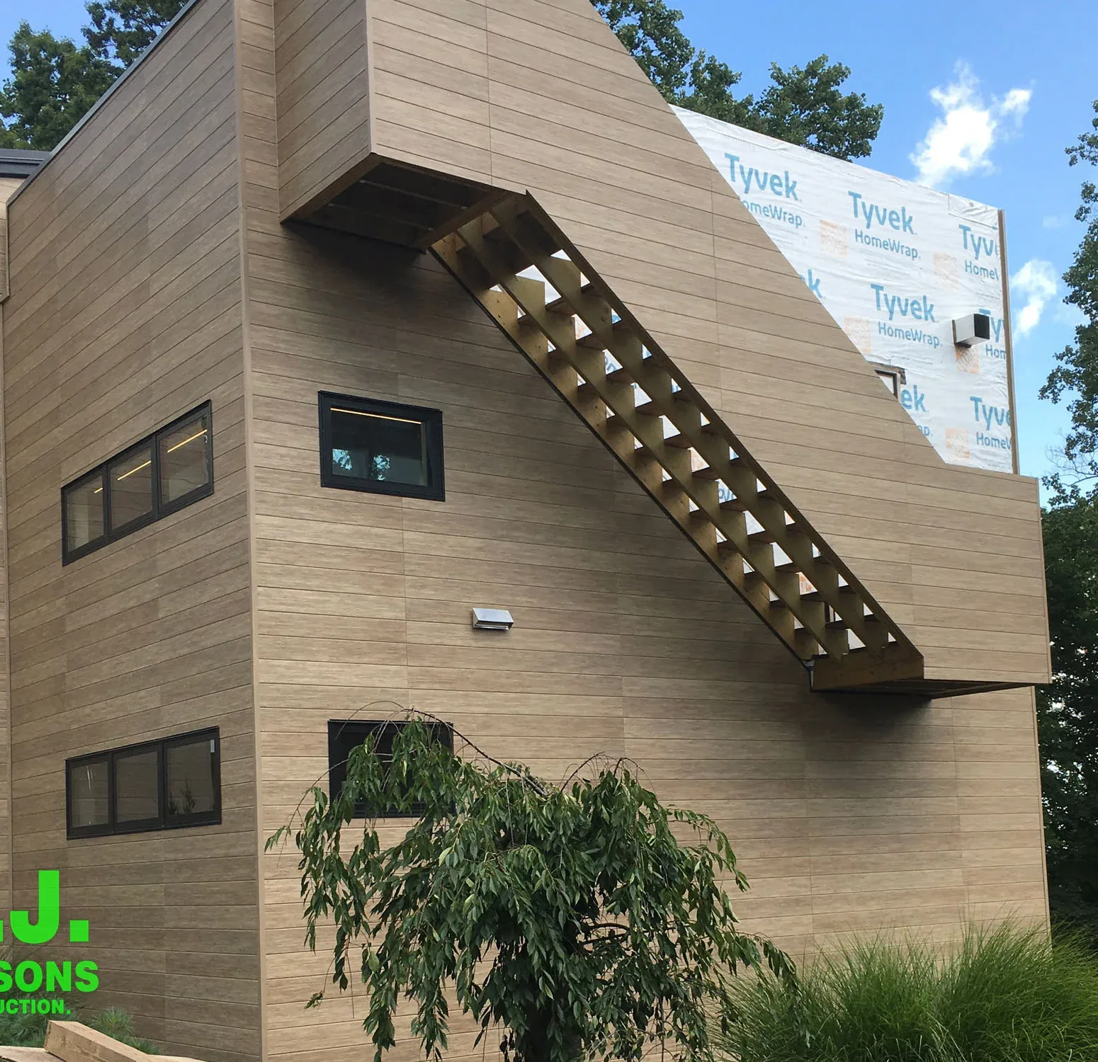 Exterior view featuring Nichiha fiber cement siding, a durable and stylish alternative to traditional wood siding, showcasing a modern and appealing facade with a wood-like appearance