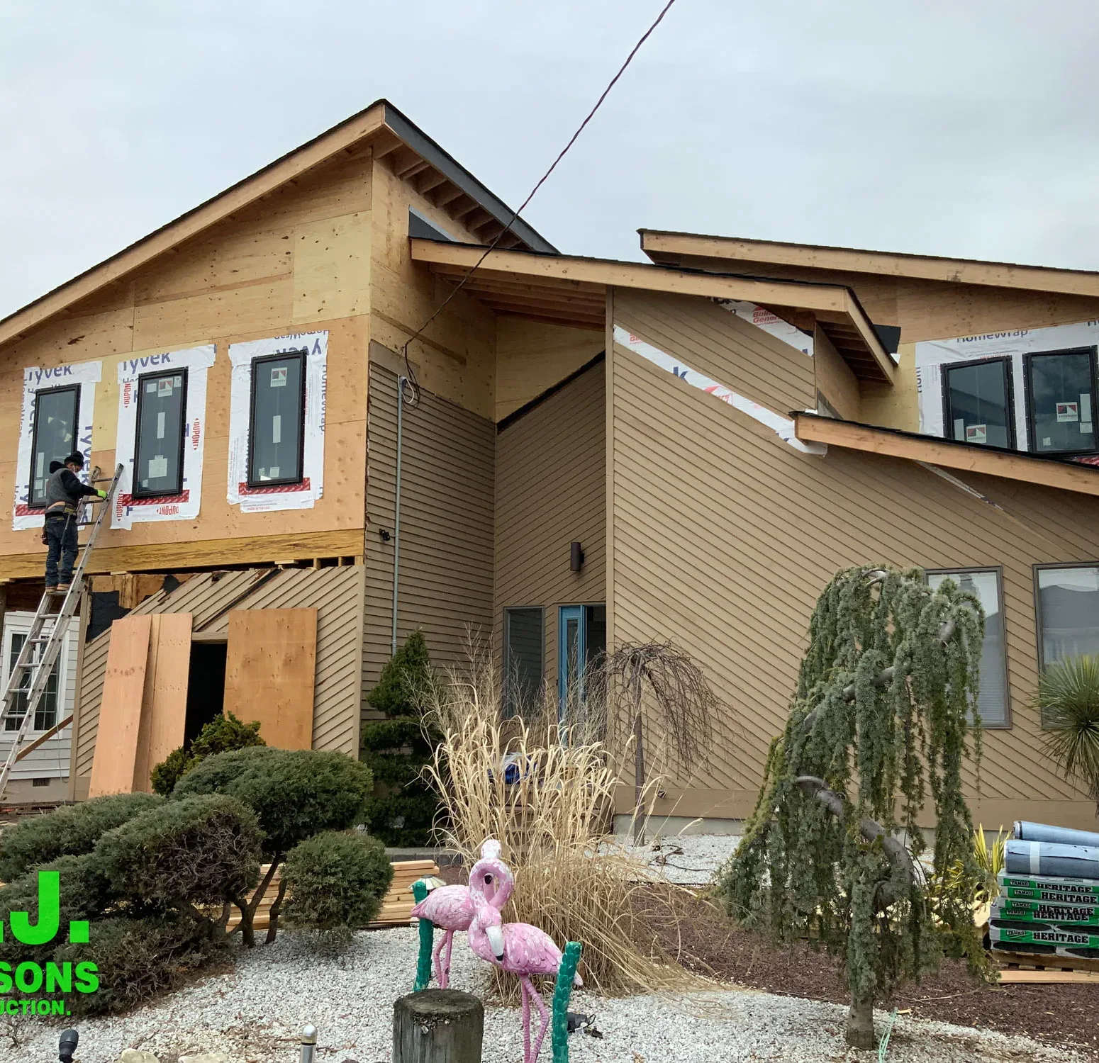 Removing old siding and exposing bare wall sheathing for preperation to install Nichija siding
