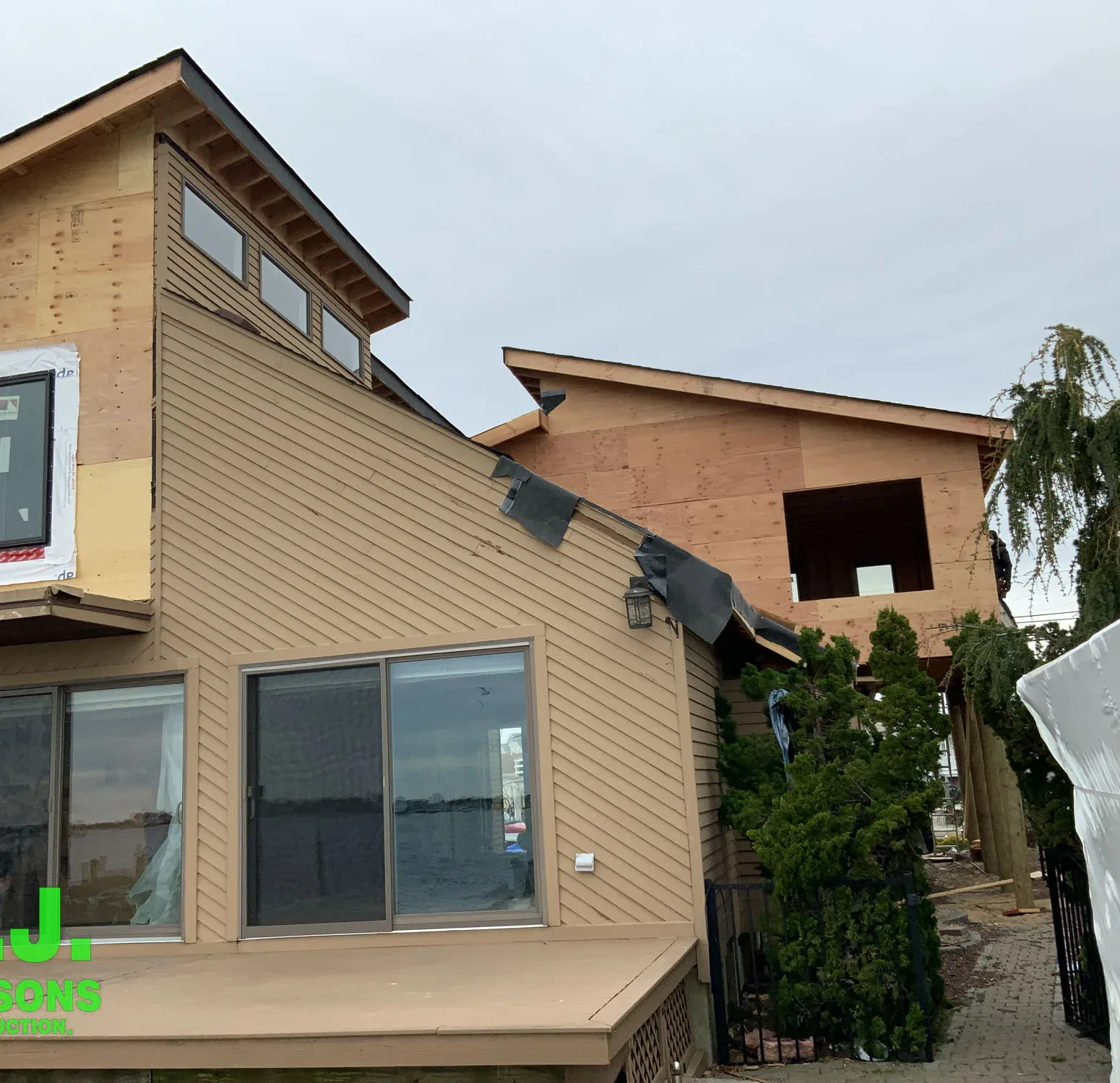 Removing old siding and exposing bare wall sheathing for preperation to install Nichija siding