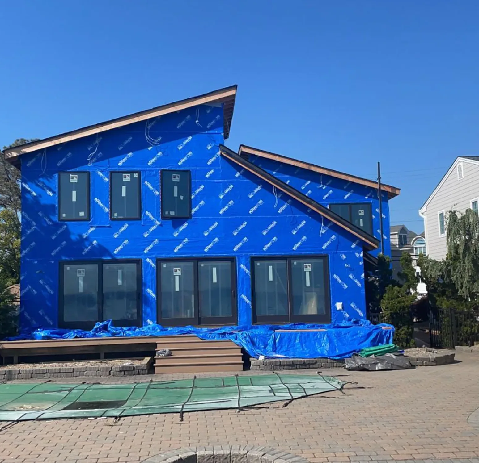 Bare house covered in homewrap getting ready to install Nichiha siding
