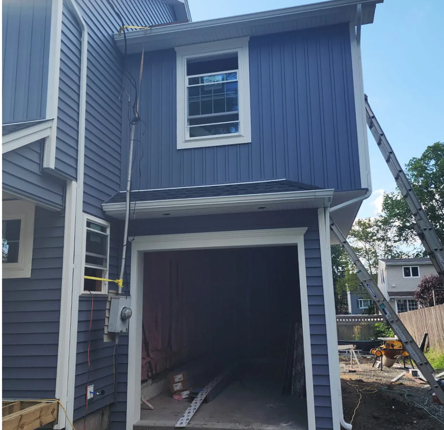 Norandex vinyl siding installation complemented by Azek moldings and trim. The rich, deep blue hue adds sophistication and timeless elegance to your home exterior