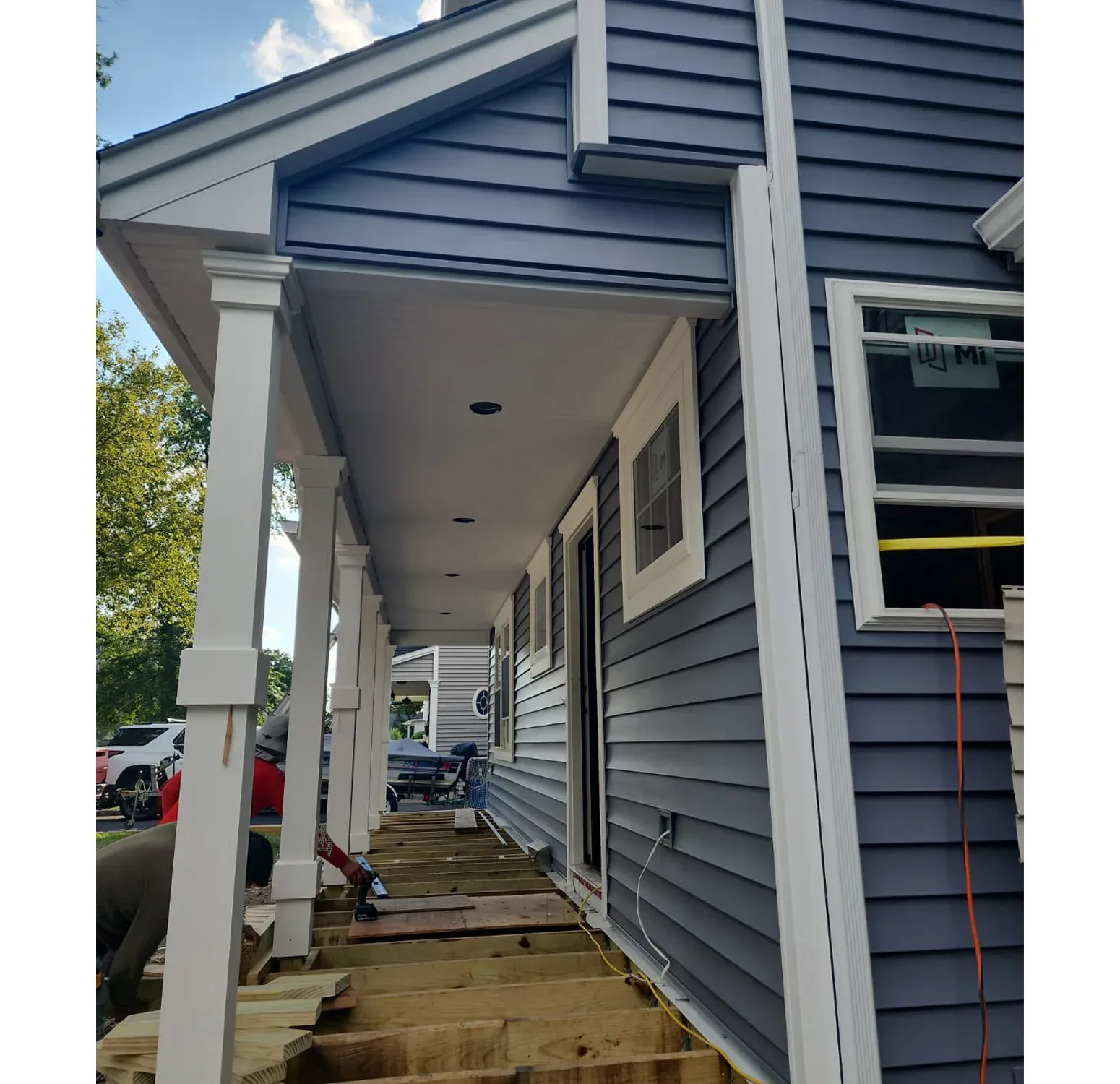 Norandex vinyl siding installation paired with Azek moldings and columns. Elevating curb appeal with a blend of durability and timeless design