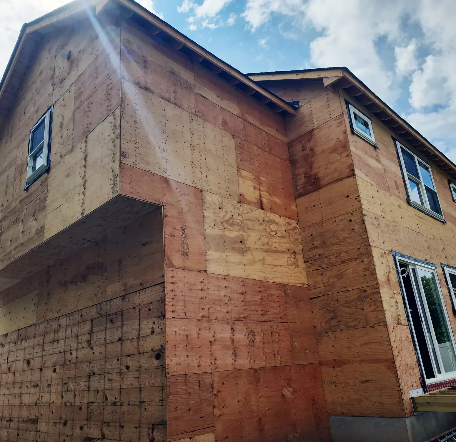 Removing old siding to bare wall sheathing, getting home ready for deep blue Norandex vinyl siding
