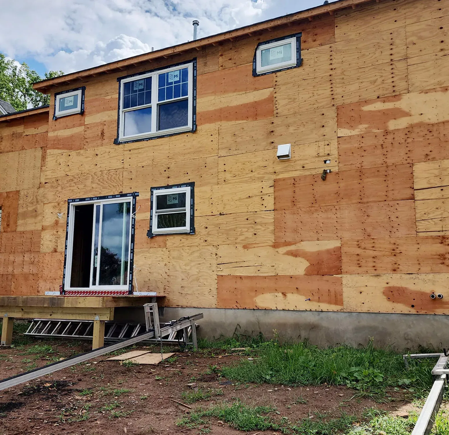 Removing old siding to bare wall sheathing, getting home ready for deep blue Norandex vinyl siding