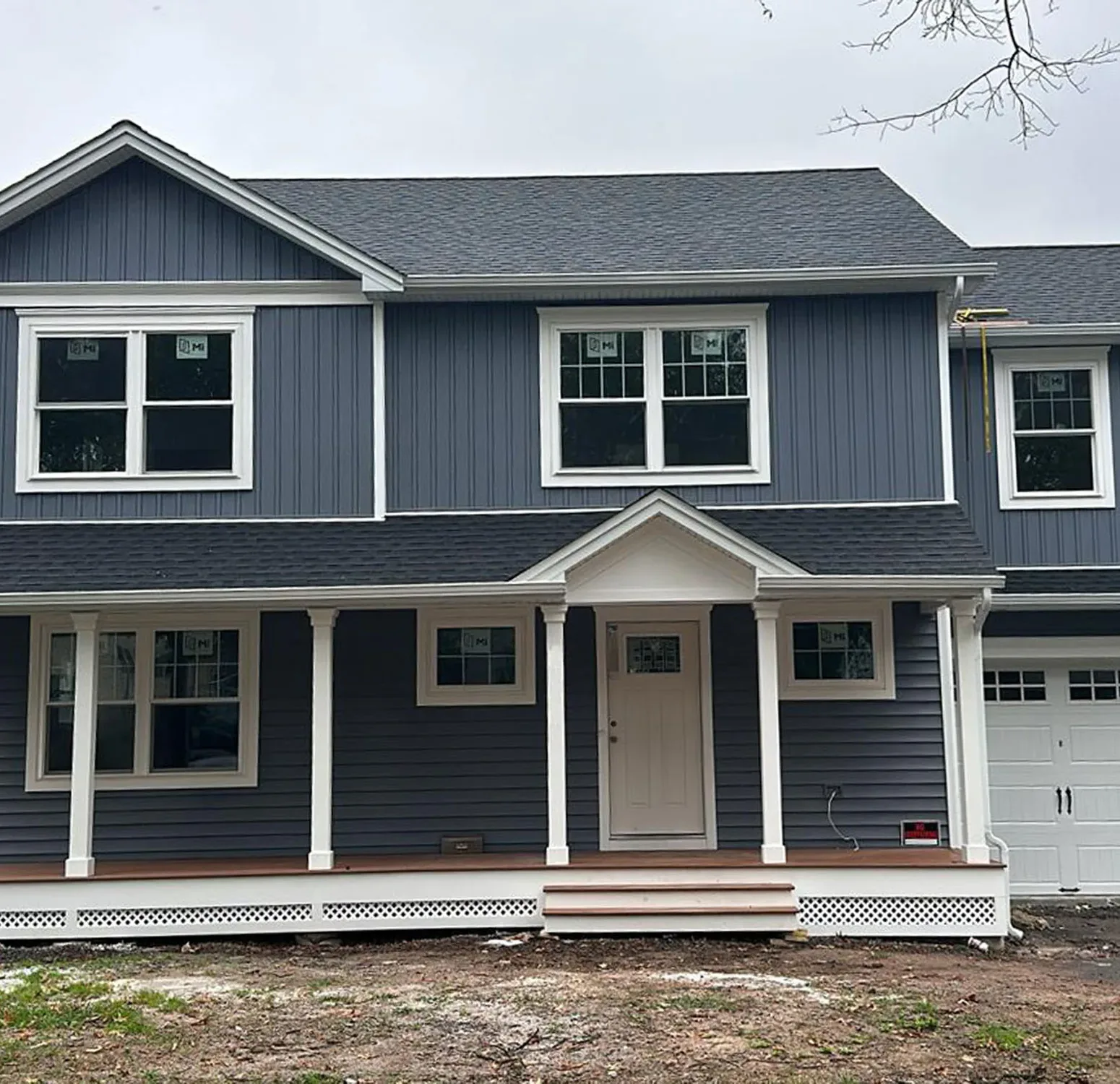 Norandex vinyl siding installation paired with Azek moldings and columns. Elevating curb appeal with a blend of durability and timeless design