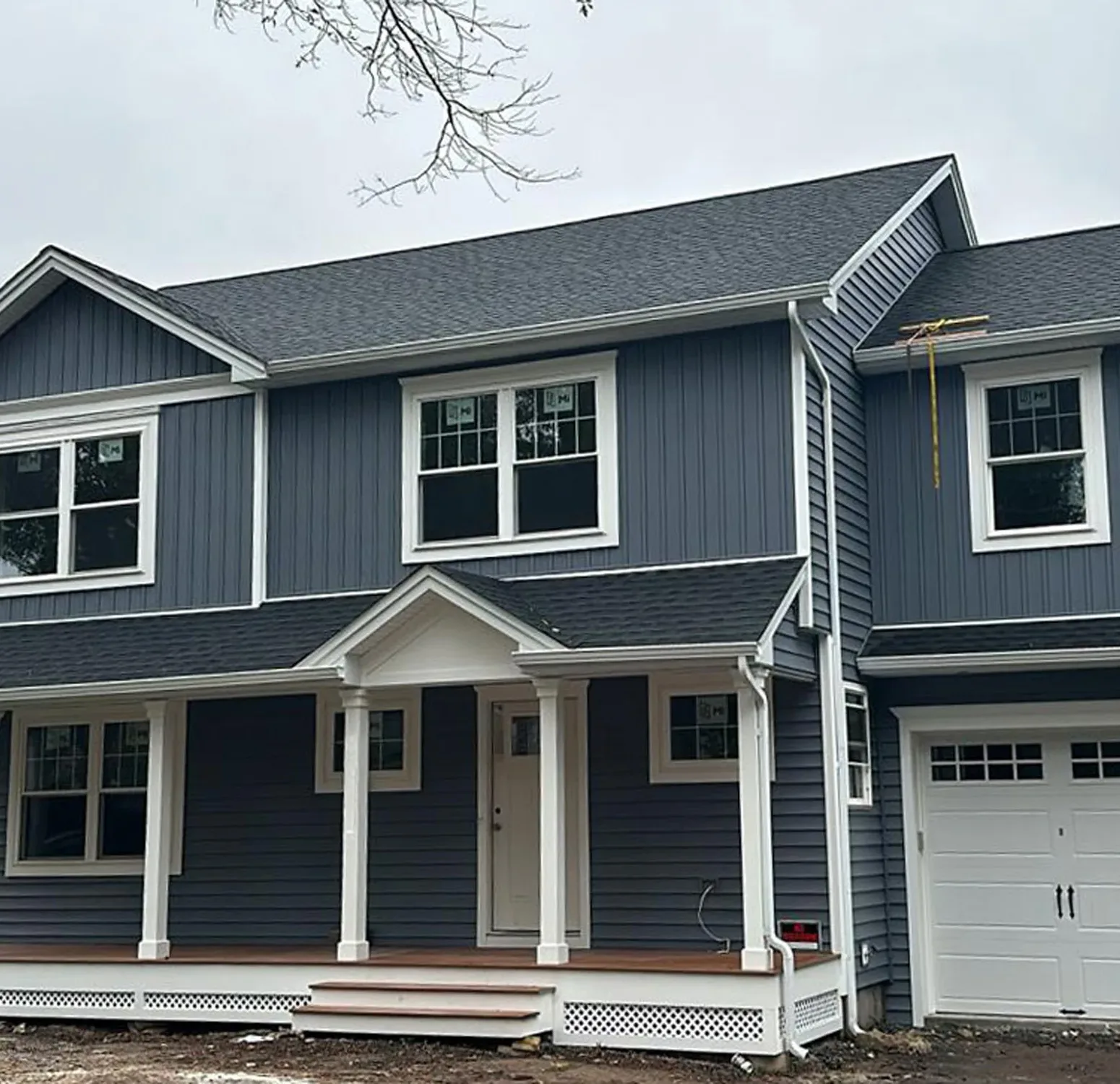 Norandex vinyl siding installation paired with Azek moldings and columns. Elevating curb appeal with a blend of durability and timeless design