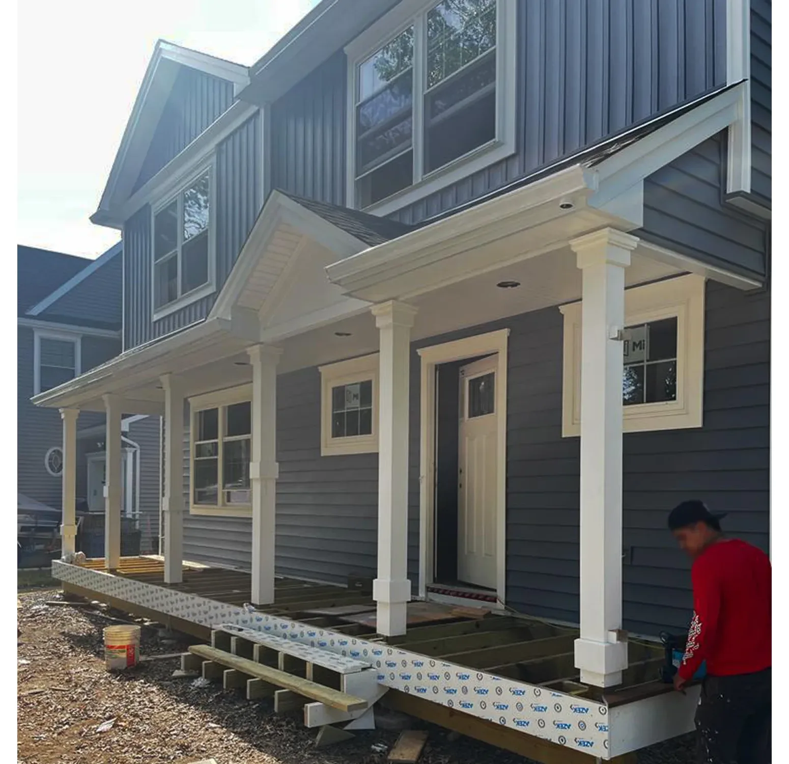 Norandex vinyl siding installation paired with Azek moldings and columns. Elevating curb appeal with a blend of durability and timeless design